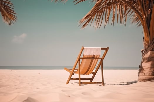 Beach chair near palm tree on tropical beach . Summer vacation concept. photo