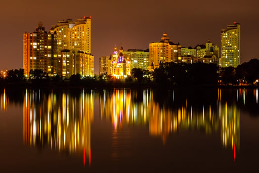 night city with reflection of houses in the river photo