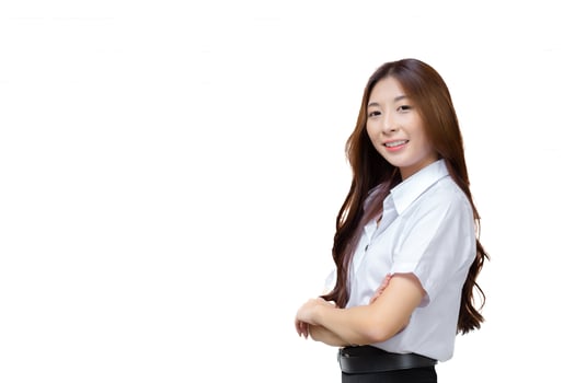 Portrait of adult Thai student. Cute Asian young girl student in uniform is smiling and looking at camera with her arms crossed confidently isolated on white background. photo