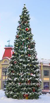 Close up decorated christmas tree balls bauble and New Year's garlands on outside in town square - xmas and winter holidays in cityscape photo