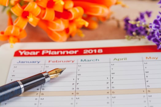 personal organizer or planner with fountain pen on wood table. photo
