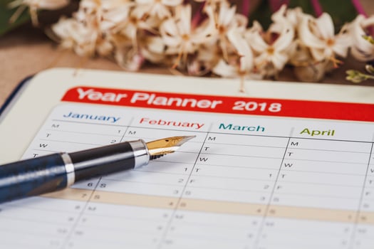 personal organizer or planner with fountain pen on wood table. photo