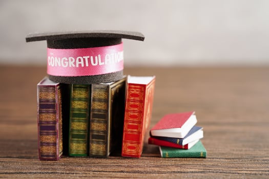 Graduation hat on book with copy space, learning university education concept. photo