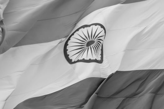 India flag flying high at Connaught Place with pride in blue sky, India flag fluttering, Indian Flag on Independence Day and Republic Day of India, tilt up shot, Waving Indian flag, Har Ghar Tiranga photo