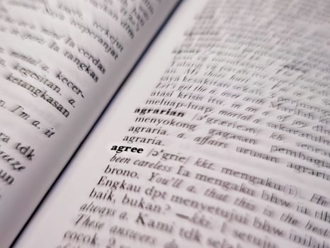 a close up of the word agree in the English to Indonesian dictionary. For word background or wallpaper photo