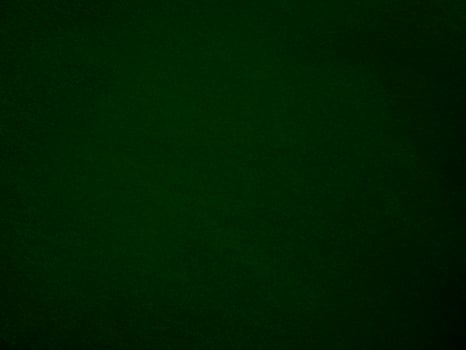 Dark green old velvet fabric texture used as background. Empty green fabric background of soft and smooth textile material. There is space for text.. photo