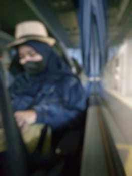 A defocused blur of a Muslim woman traveling during the pandemic. photo