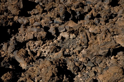original brown natural background of volcanic congealed lava in close-up photo