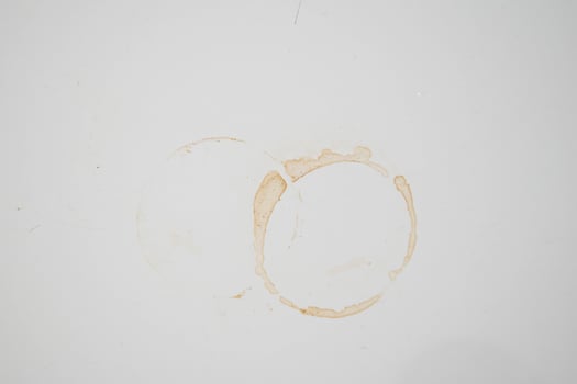 plain white background with brown stains of black coffee mug photo