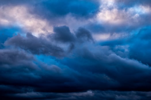 menacing dark navy clouds forming a picturesque orignial background photo