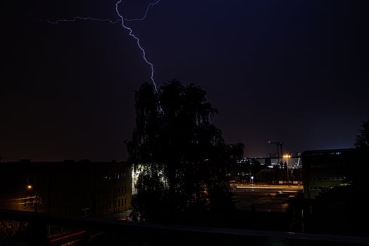 beautiful night summer suburban landscape with storm and lightning photo