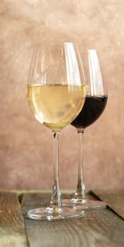 Glasses of white and red wine photo
