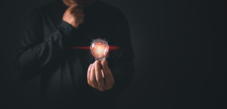 person hand holding power lightbulb and pretend to think, inspiration, creativity and imagination concept, innovation technology success business. photo