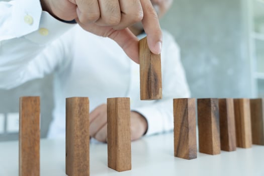 insurance with hands protect domino. hands stop dominoes falling crisis. business risk control and plan and strategies to run prevent businesses. deposits, medical expenses, rent, family care. photo