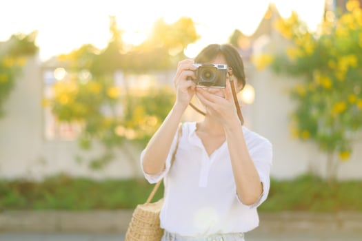 Portrait of asian woman traveler using camera at street of Bangkok, Thailand. Asia summer tourism vacation concept photo