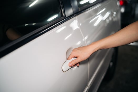Business woman hand open person white car. Automobile vehicle female owner catching a door handle. Driver, service, lock, automotive insurance concept. photo