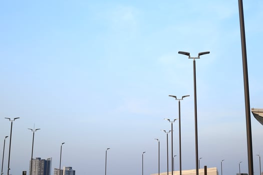 white clouds blue sky with lamp post background and building photo