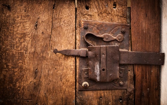 Old lock of a wooden door's Trullo in Alberobello. photo