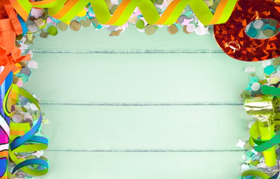 Colorful confetti and streamers on a wooden background photo