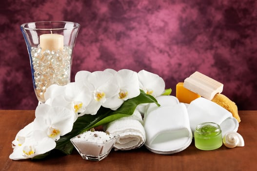 Spa accessories on wooden table on purple background photo