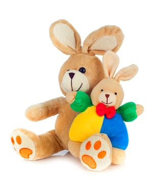A stuffed rabbit and bunny sitting next to each other photo