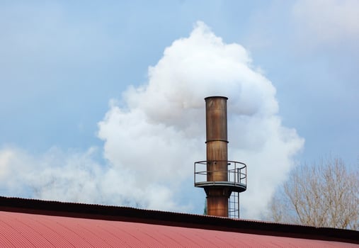 Chimney of a factory, Industrial process that produces white smoke. photo