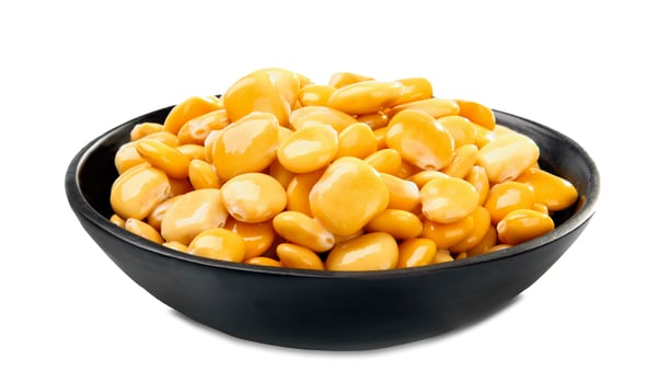 A bowl of yellow beans on a white background photo