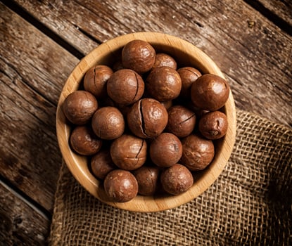 Macadamia nuts on wooden table. photo