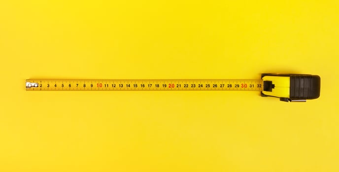 Yellow Measuring Tape on yellow background. photo