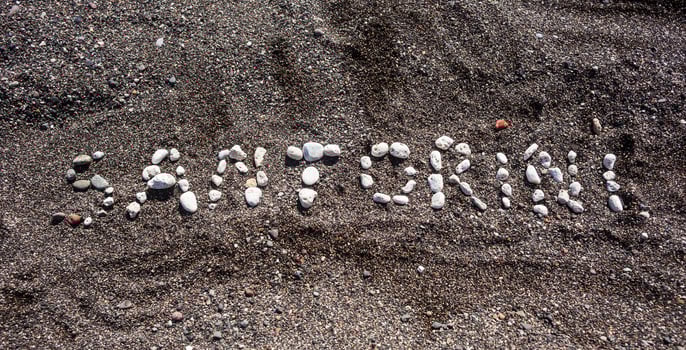 Text Santorini made with pumice stones photo