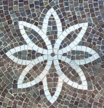 A mosaic tile with a flower design on it photo