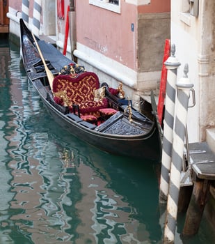 A black boat with red and gold trim photo