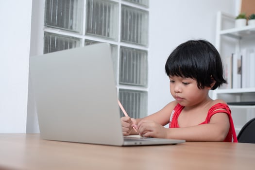 Happy Asian girl student online learning class from a computer with a teacher, online education is a technology for social distance in a new normal lifestyle, Concept of home school and tutor photo