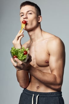 athletic man with a pumped-up torso plate of salads healthy eating eating lifestyle photo