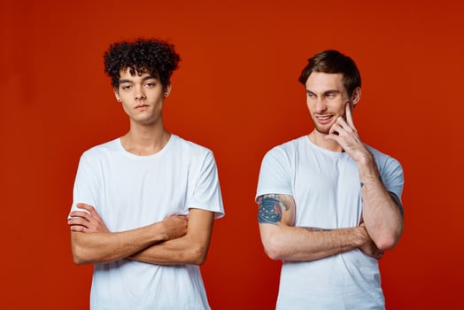 two friends in white t-shirts communication lifestyle red background photo