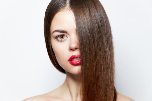 Woman portrait Looking forward red lips hair covering her face clear skin photo