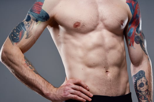 man with a pumped-up torso tattoo on his arms photo