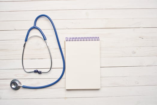 wooden background stethoscope notepad treatment medicine hospital photo