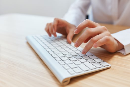 Closeup shot hands of businesswoman journalist office worker freelancer typing report doing documents on keyboard. Online communication, Remote job or Education. Copy space, wide angle photo