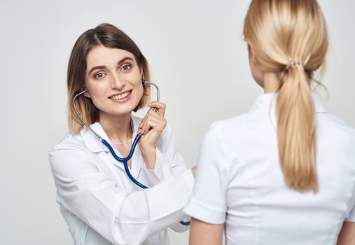 nurse in medical gown stethoscope and patient back view photo