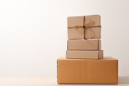 Woman hands holding present box with a ribbon bow. Concept of gift  box minimalist style. Showing brown cardboard boxes delivery someone in special occasions or parcel deliver service. photo