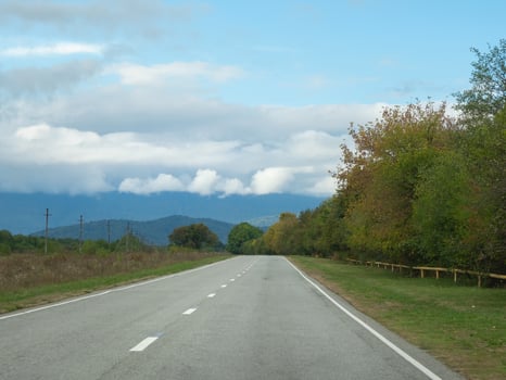Highway through the autumn forest natural way concept, road to the caucasian forest nature field, relaxing with ecological environment. Mountain Digoria is a national park in North Ossetia photo