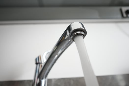 water pouring from a faucet tap slow motion photo