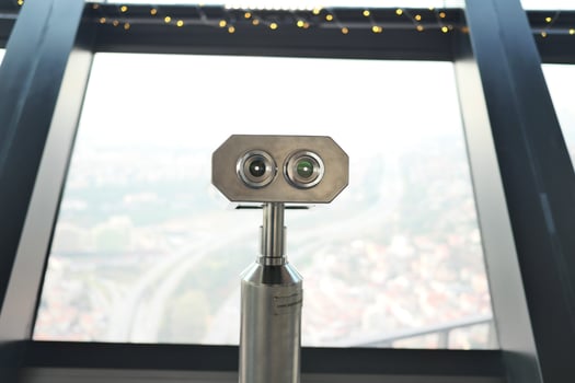 Coin-operated binoculars looking out over city , photo