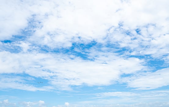 Beautiful blue sky and white clouds abstract background. Cloudscape background. Blue sky and fluffy white clouds on sunny day with birds flying. Nature weather. Beautiful blue sky on a summer day. photo