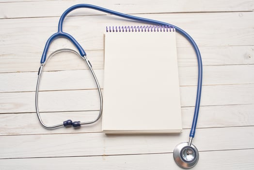 wooden background stethoscope notepad treatment medicine hospital photo