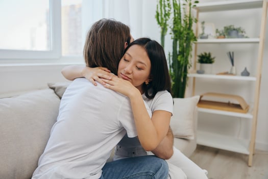 An Asian woman hugs her husband and smiles. The joy of using the family and the good psychological state after the quarrel photo