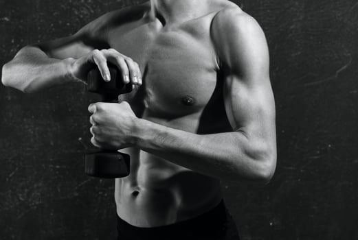 man with a pumped-up torso in gloves workout exercises muscles photo