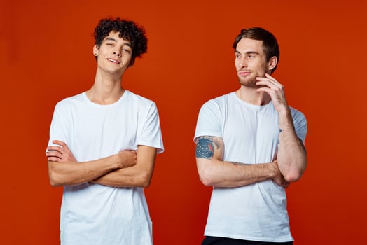 two friends in white t-shirts communication lifestyle red background photo