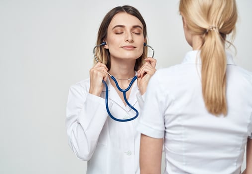 nurse in medical gown stethoscope and patient back view photo